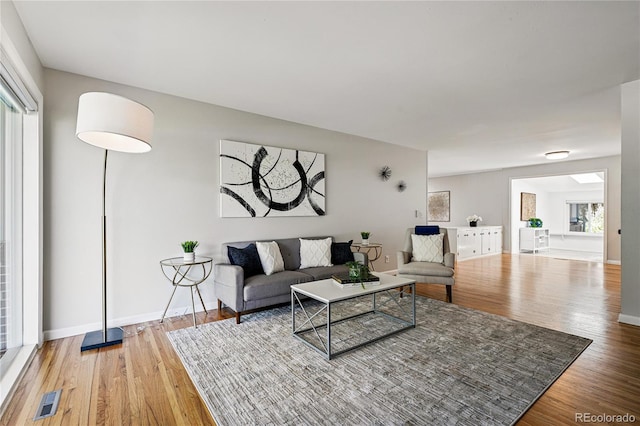 living room featuring wood finished floors and baseboards