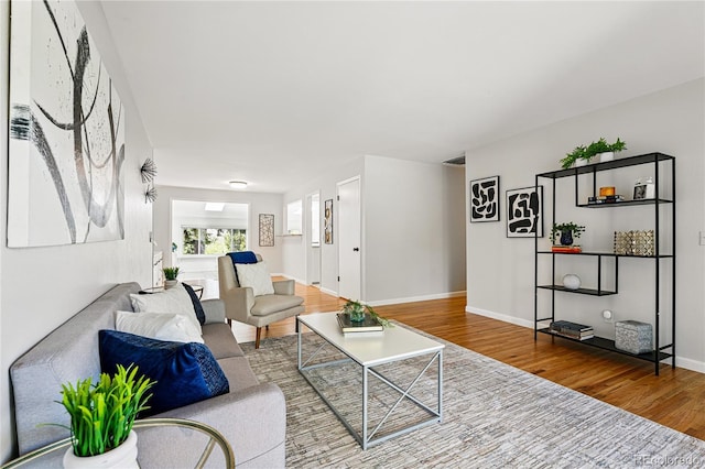 living room featuring wood finished floors and baseboards