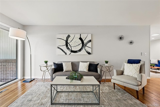 living area featuring wood finished floors, baseboards, and recessed lighting