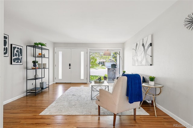 entrance foyer featuring wood finished floors and baseboards