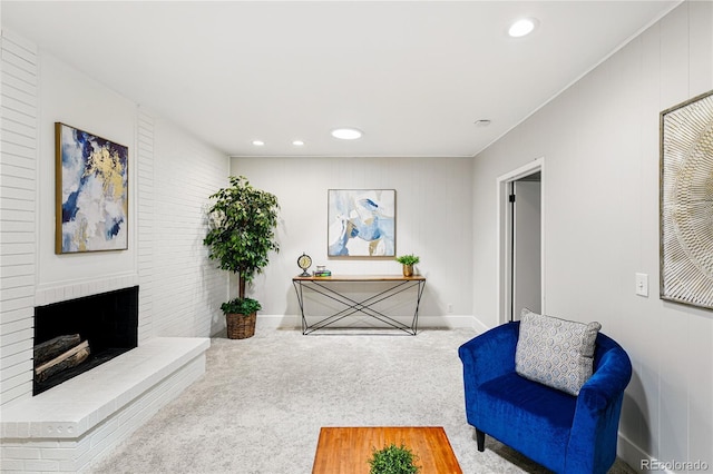 living area featuring carpet floors, recessed lighting, a brick fireplace, and baseboards