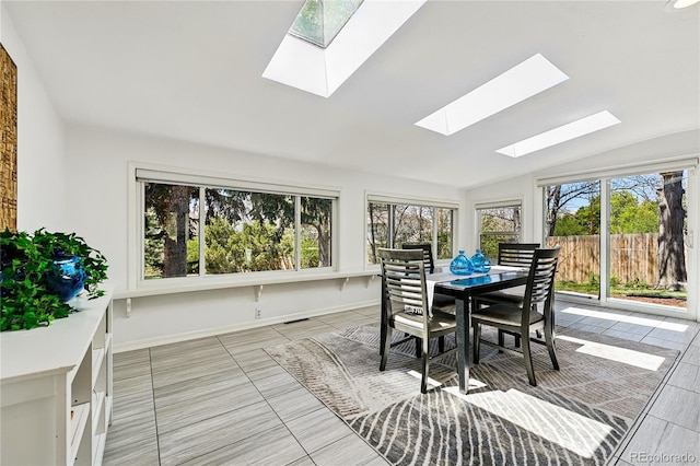 sunroom with a skylight and lofted ceiling