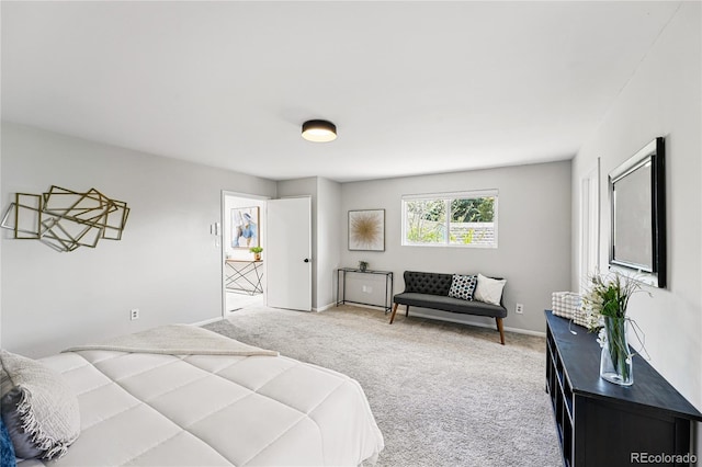 bedroom with light colored carpet and baseboards