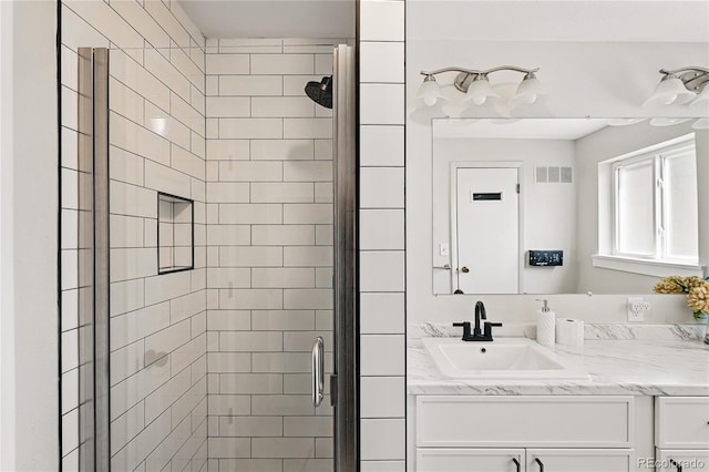 full bathroom with a stall shower and vanity