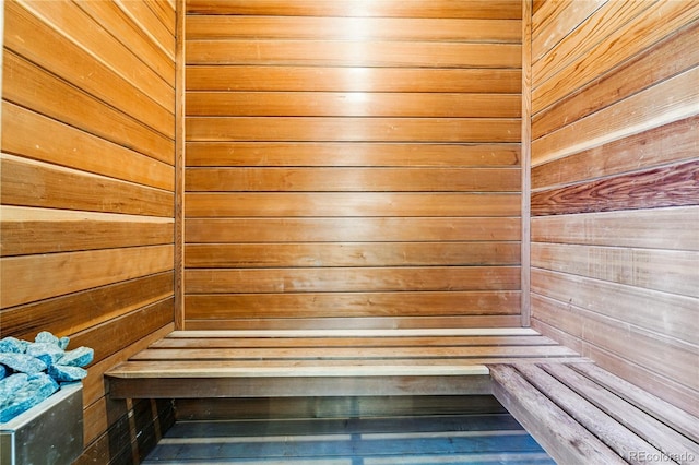 sauna / steam room featuring wood walls