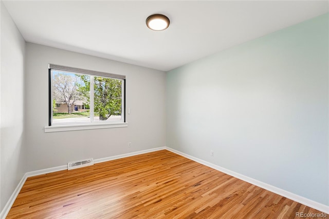 unfurnished room featuring light wood finished floors and baseboards