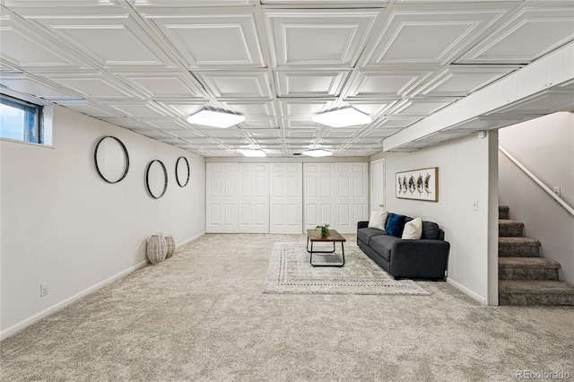 living area with carpet, stairway, baseboards, and an ornate ceiling