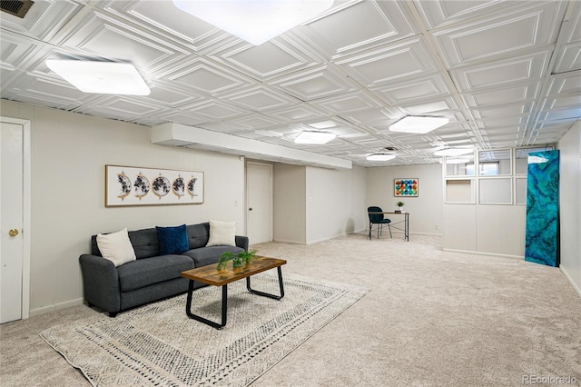 living room with carpet flooring, baseboards, and an ornate ceiling