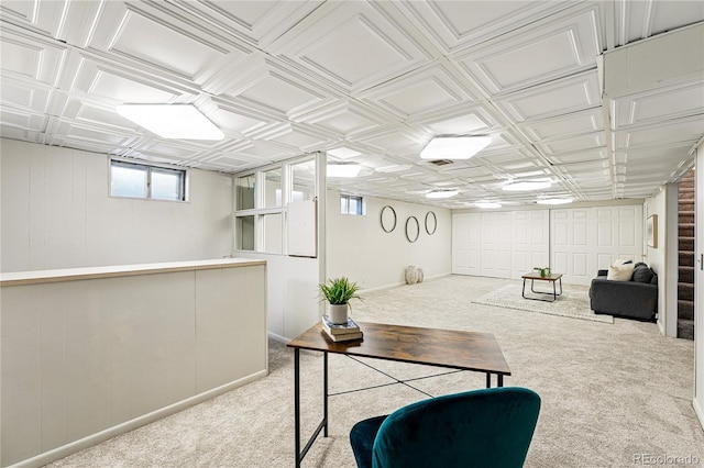 below grade area featuring carpet floors and an ornate ceiling