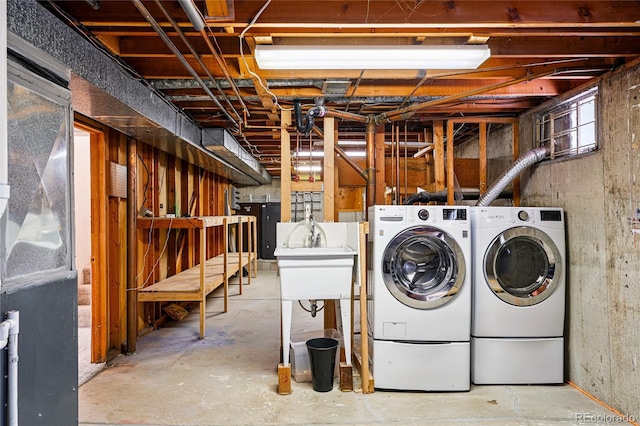 clothes washing area with washing machine and dryer