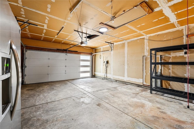 garage featuring a garage door opener and freestanding refrigerator