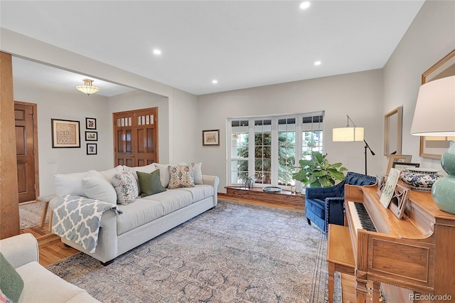 living area featuring wood finished floors and recessed lighting