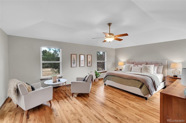 bedroom featuring light wood-style flooring, lofted ceiling, and ceiling fan