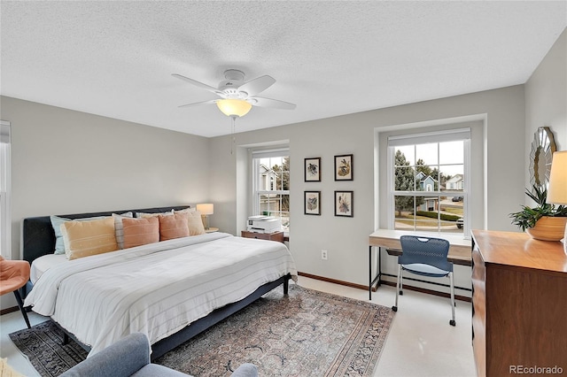 bedroom featuring baseboards, a textured ceiling, and a ceiling fan