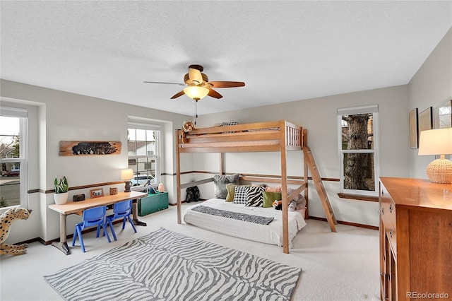 bedroom with baseboards, carpet, ceiling fan, and a textured ceiling