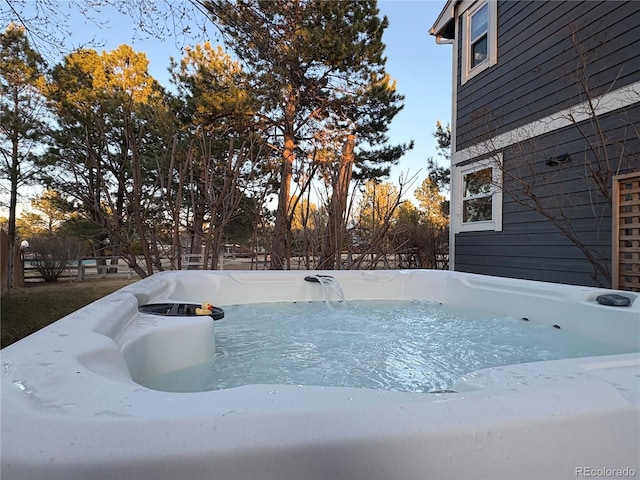 view of pool with a hot tub