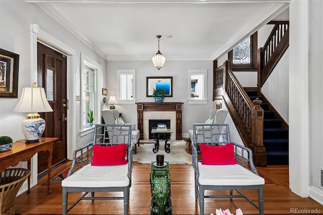 living room with stairway, a fireplace, crown molding, and baseboards