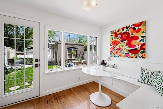 doorway featuring hardwood / wood-style floors and baseboards