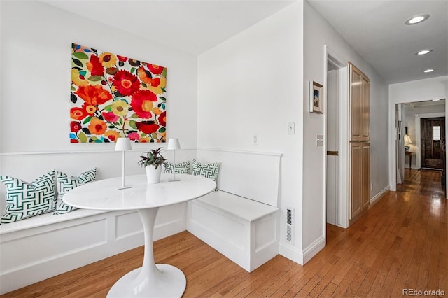 dining area with light wood-style floors, recessed lighting, breakfast area, and baseboards