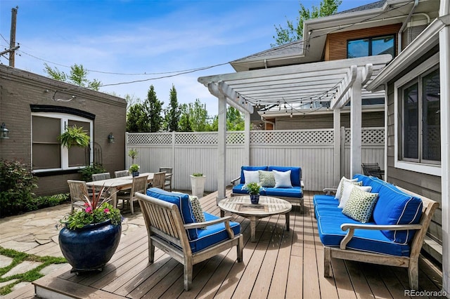 deck with outdoor lounge area, a pergola, fence, and outdoor dining space