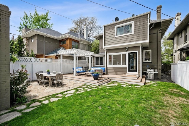 back of property with a pergola, outdoor lounge area, and a wooden deck