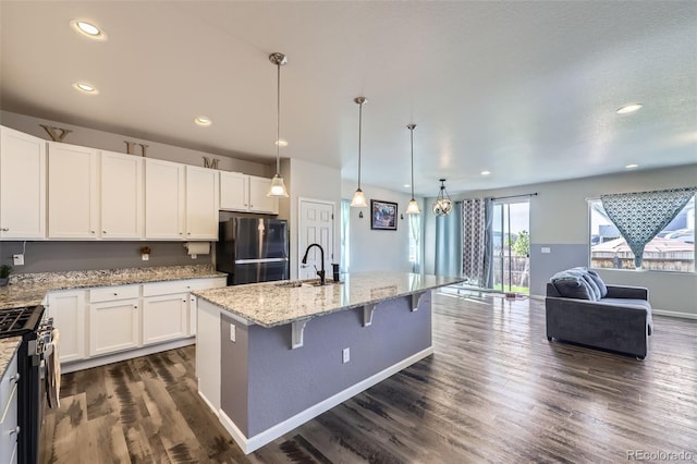 6924 E 118th Pl, Thornton, CO 80233 - kitchen featuring freestanding refrigerator, gas stove, a sink, open floor plan, and light stone counters