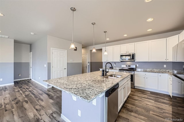 6924 E 118th Pl, Thornton, CO 80233 - kitchen featuring stainless steel appliances, a sink, dark wood-style flooring, white cabinets, and light stone countertops