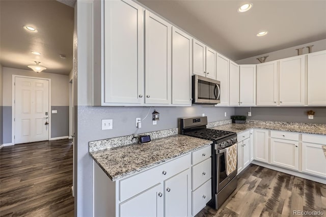 6924 E 118th Pl, Thornton, CO 80233 - kitchen with stainless steel appliances, dark wood finished floors, white cabinets, and recessed lighting