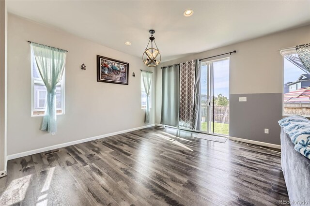 6924 E 118th Pl, Thornton, CO 80233 - unfurnished dining area with wood finished floors, a chandelier, baseboards, and recessed lighting