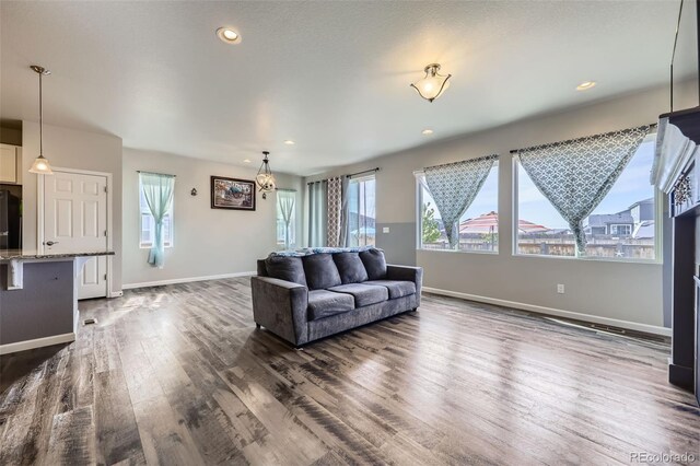 6924 E 118th Pl, Thornton, CO 80233 - living area with dark wood-style flooring, baseboards, and recessed lighting