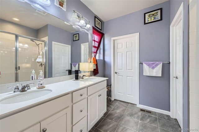 6924 E 118th Pl, Thornton, CO 80233 - full bathroom featuring double vanity, a stall shower, and baseboards