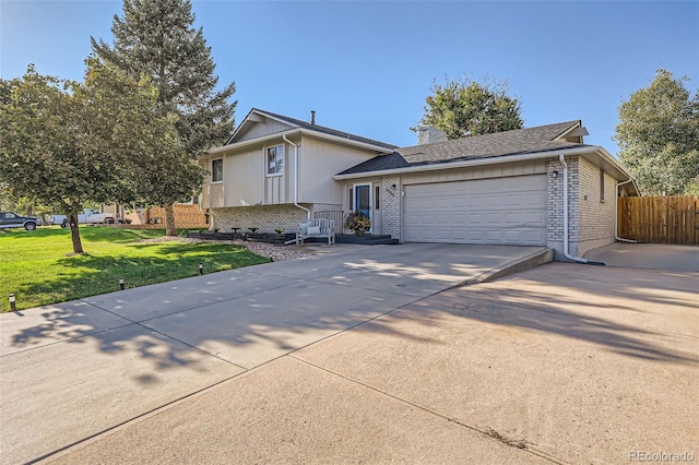 tri-level home with an attached garage, brick siding, fence, concrete driveway, and a chimney