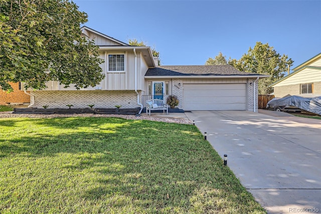 split level home featuring a garage, driveway, brick siding, and board and batten siding