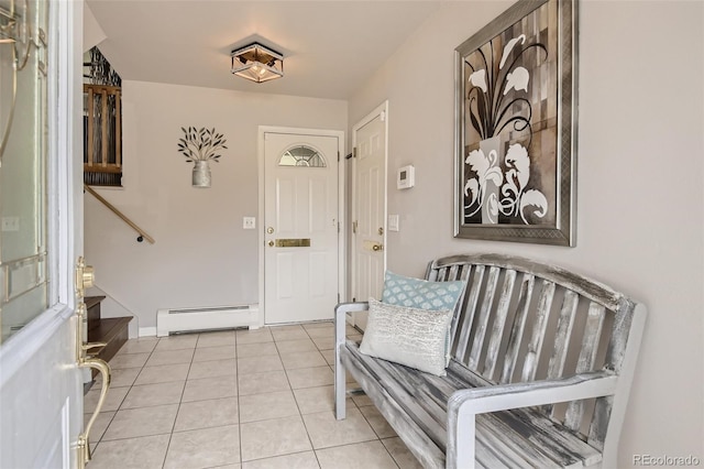 foyer with light tile patterned floors, stairway, and a baseboard radiator