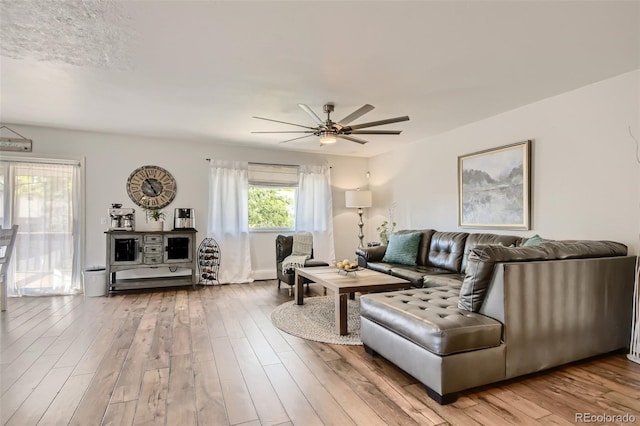 living room with a ceiling fan and wood finished floors