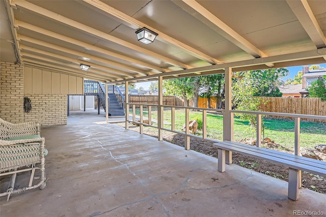 view of patio / terrace featuring a fenced backyard and stairs