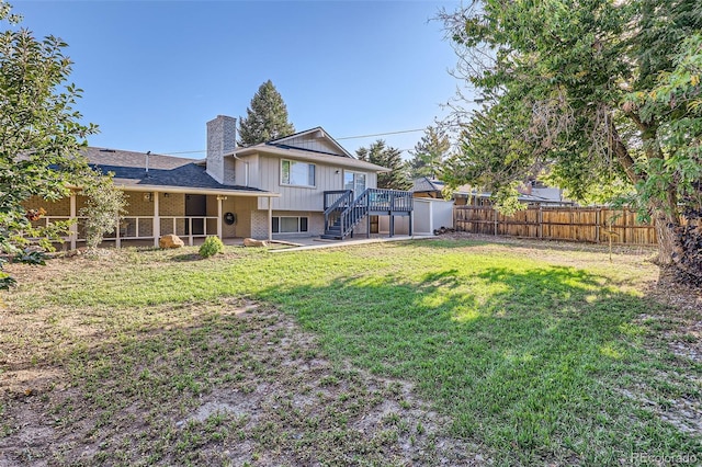 view of yard with a fenced backyard, stairs, and a deck