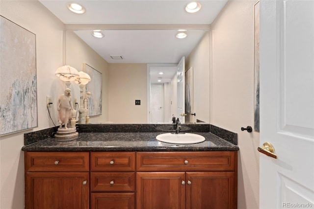 bathroom with recessed lighting, visible vents, and vanity