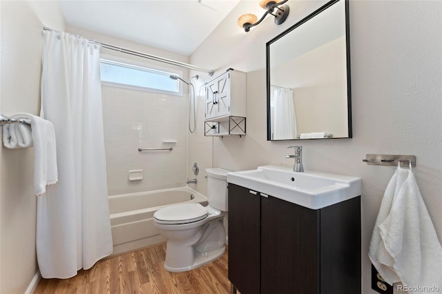 bathroom featuring shower / bath combo with shower curtain, vanity, toilet, and wood finished floors