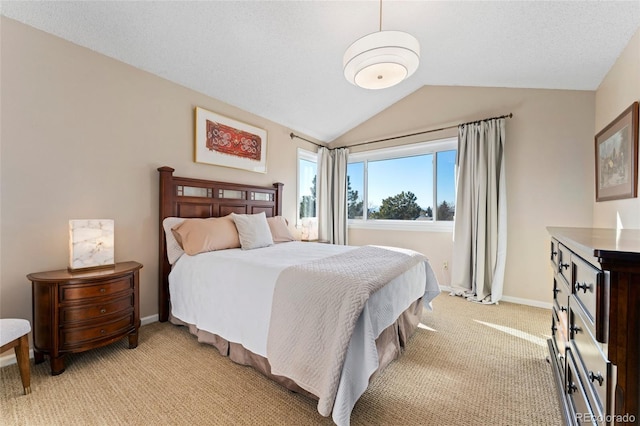 bedroom featuring lofted ceiling, light carpet, and baseboards