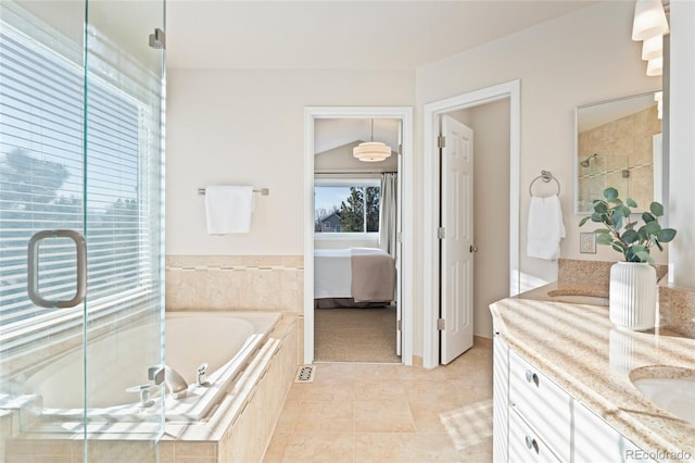 ensuite bathroom featuring ensuite bathroom, tile patterned flooring, a garden tub, double vanity, and a stall shower