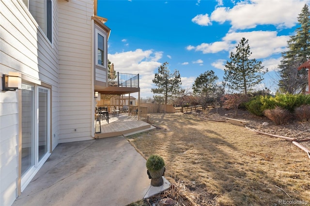 view of yard featuring a patio area and a wooden deck