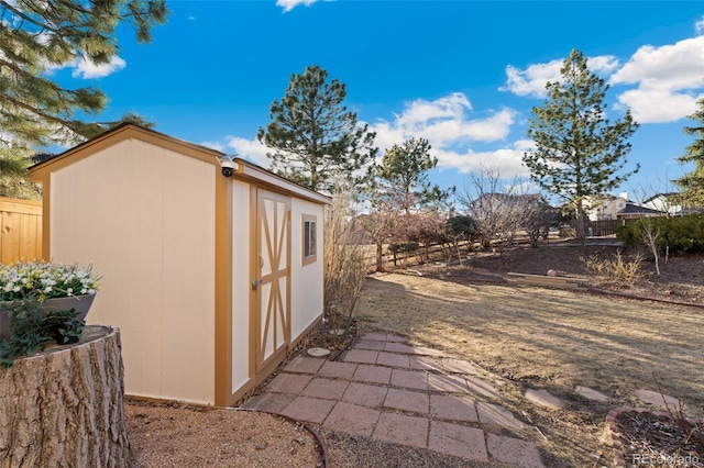 exterior space with a storage shed, an outdoor structure, and fence