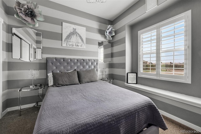bedroom featuring baseboards and carpet