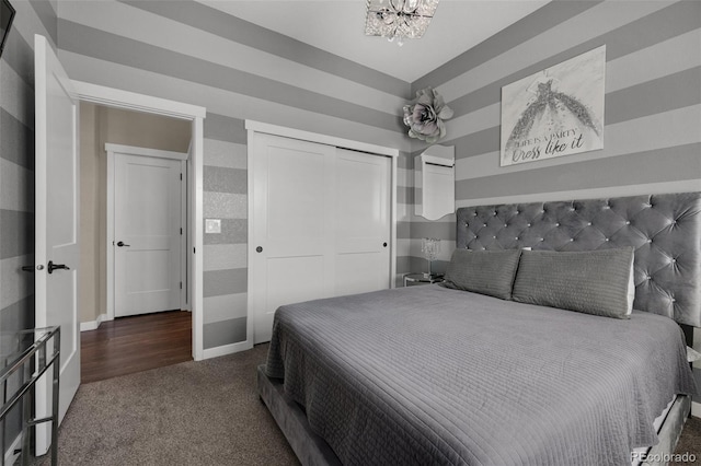 carpeted bedroom featuring baseboards and a notable chandelier