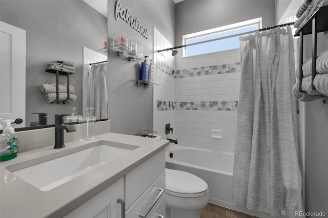 full bath featuring vanity, a textured wall, shower / bath combination with curtain, and toilet
