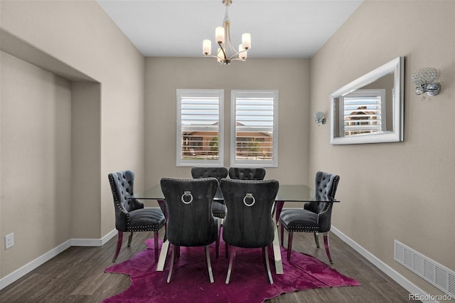 dining space with an inviting chandelier, a wealth of natural light, and dark hardwood / wood-style flooring