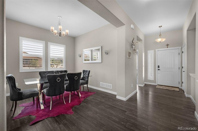 dining area with an inviting chandelier and dark wood-type flooring