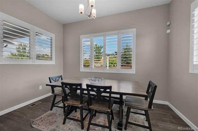 dining area with baseboards, a notable chandelier, dark wood-style floors, and visible vents