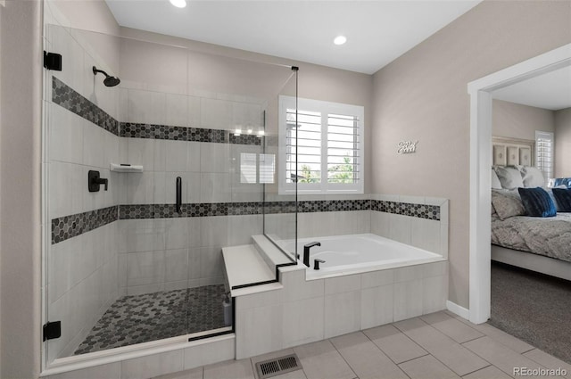 bathroom featuring tile patterned flooring and independent shower and bath